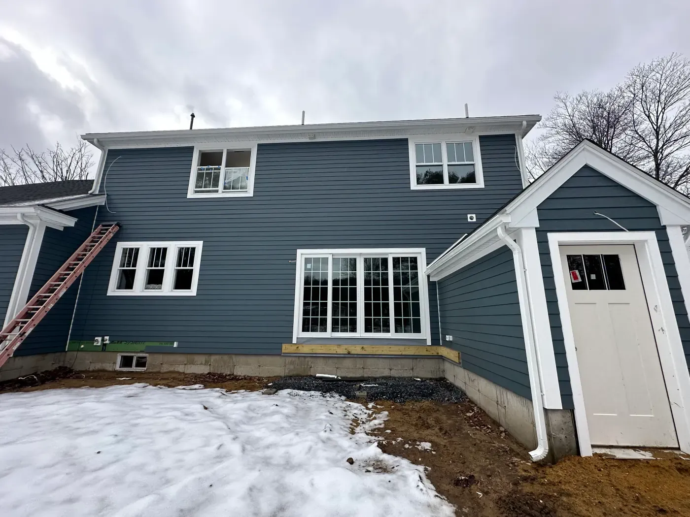New navy blue lap siding installed on a New England home by FBS Construction